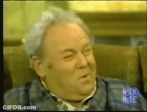 Gray Hair Man Sitting With Nick Nite Sign GIF