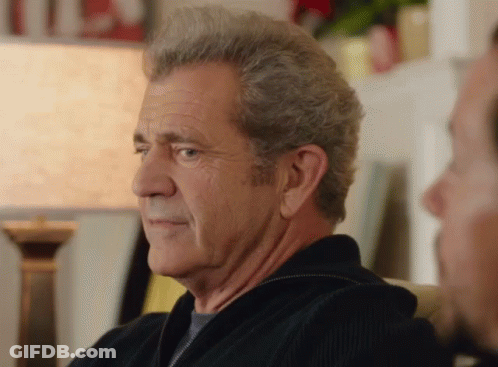 A Man With Gray Hair Is Sitting On A Couch With Another Man GIF