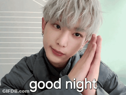 A Man With Gray Hair Says " Good Night " With His Hands Folded GIF