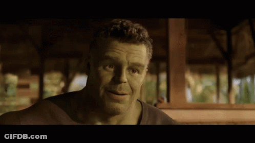 A Man With Green Hair And A Beard Is Looking At The Camera GIF