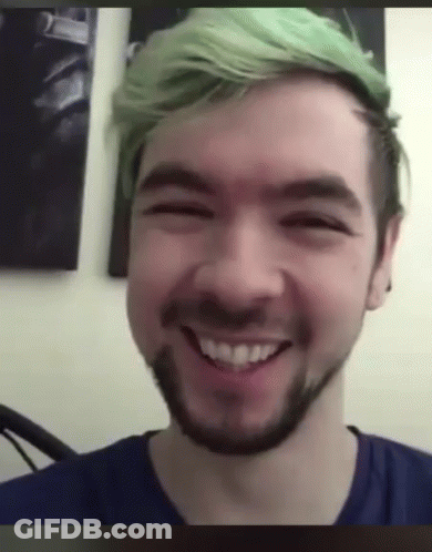 A Man With Green Hair And A Beard Is Smiling GIF
