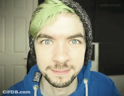A Man With Green Hair And A Beard Wears A Blue Hoodie GIF