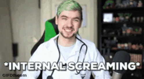 A Man With Green Hair And A Stethoscope Around His Neck Is Sitting In A Chair . GIF