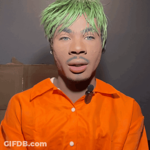 A Man With Green Hair And An Orange Shirt GIF