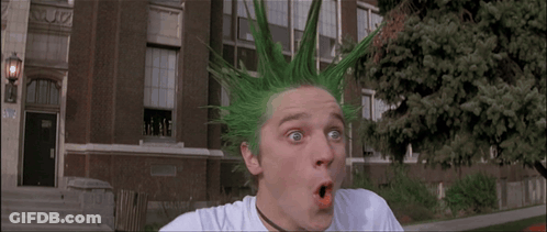 A Man With Green Hair Has A Surprised Look On His Face In Front Of A Building GIF
