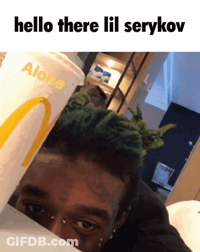 A Man With Green Hair Is Behind A Mcdonald 'S Cup That Says Alone On It GIF