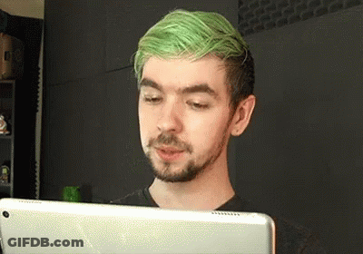 A Man With Green Hair Is Using A Tablet Computer . GIF