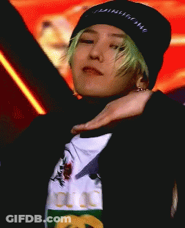 A Man With Green Hair Is Wearing A Black Beanie And A Gucci T-Shirt GIF