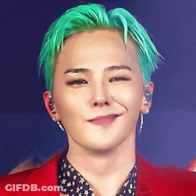 A Man With Green Hair Is Wearing A Red Jacket And Smiling GIF