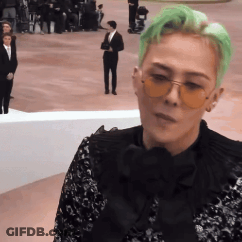 A Man With Green Hair Wearing Sunglasses And A Black Shirt GIF
