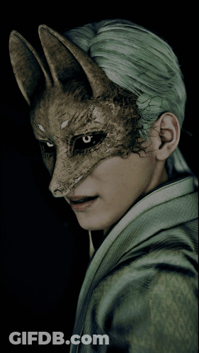 A Man With Green Hair Wears A Fox Mask GIF