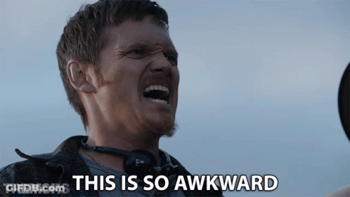 A Man With Headphones Around His Neck Is Screaming With The Words This Is So Awkward Behind Him GIF