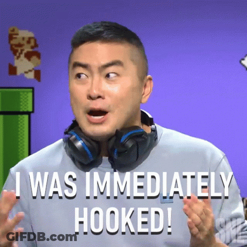 A Man With Headphones Around His Neck Says " I Was Immediately Hooked " GIF