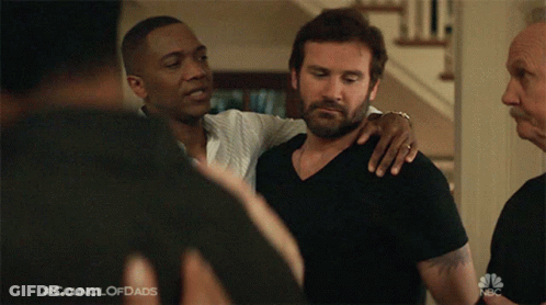 A Man With His Arm Around Another Man With The Council Of Dads Written On The Bottom Of The Screen GIF