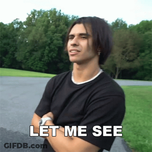 A Man With His Arms Crossed And The Words Let Me See Above Him GIF