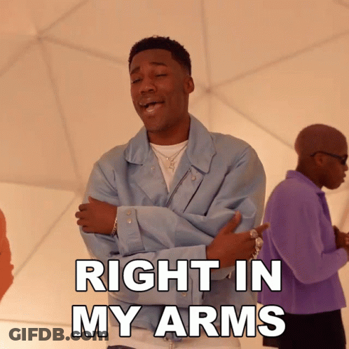 A Man With His Arms Crossed And The Words Right In My Arms GIF