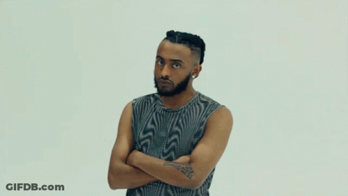 A Man With His Arms Crossed Has A Tattoo On His Arm That Says ' A ' GIF
