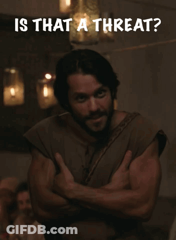A Man With His Arms Crossed Has The Words Is That A Threat Written Above Him GIF