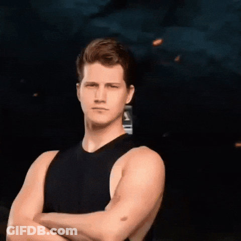 A Man With His Arms Crossed In Front Of A Bus GIF