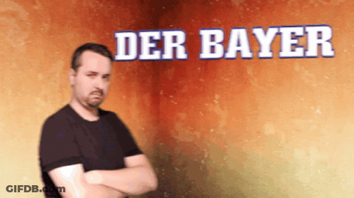 A Man With His Arms Crossed Is Standing In Front Of A Wall That Says Der Bayer GIF