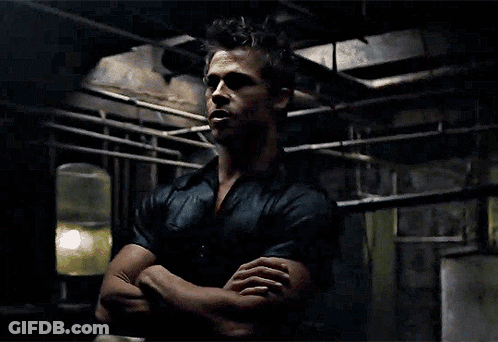 A Man With His Arms Crossed Looks At The Camera GIF