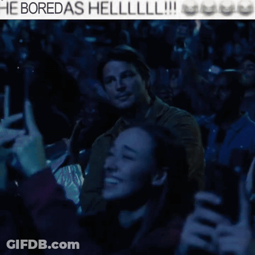 A Man With His Arms Crossed Stands In Front Of A Crowd With The Words He Boredas Helllll !!! Above Him GIF