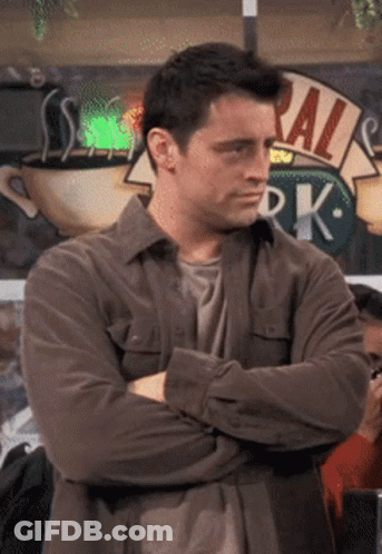 Man With Crossed Arms Standing In Front Of Ral Sign GIF
