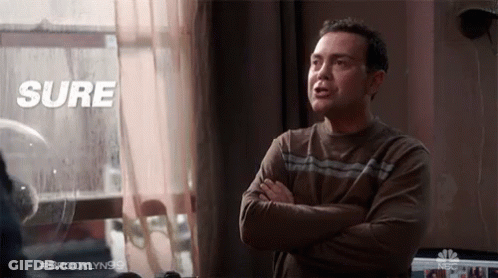 A Man With His Arms Crossed Stands In Front Of A Window With The Words Sure Above Him GIF