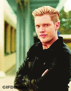 A Man With His Arms Crossed Wearing A Black Jacket GIF