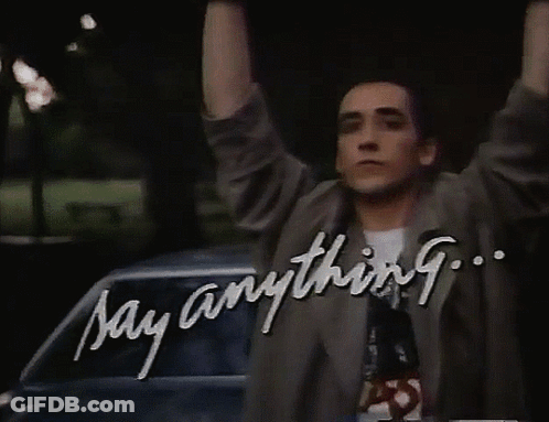 A Man With His Arms In The Air And The Words Say Anything GIF