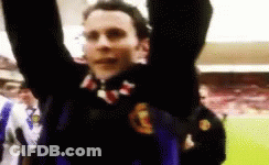 A Man With His Arms In The Air Is Wearing A Jersey With The Letter G On It GIF