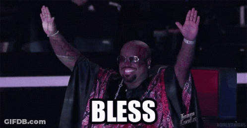 A Man With His Arms In The Air With The Word Bless Written Above Him GIF
