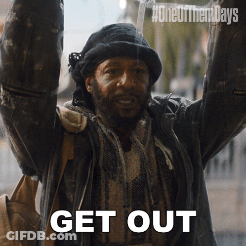 A Man With His Arms In The Air With The Words Get Out Written Below Him GIF