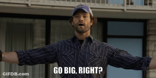 A Man With His Arms Outstretched And The Words Go Big Right Below Him GIF