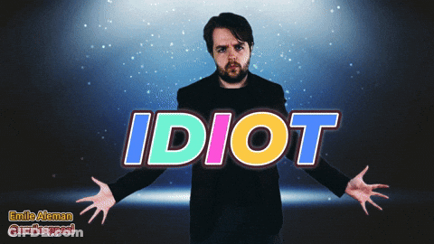 A Man With His Arms Outstretched Is Standing In Front Of The Word Idiot GIF