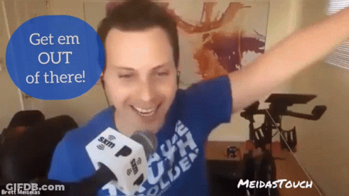 A Man With His Arms Outstretched Is Wearing A Blue Shirt That Says Brett Meiselas GIF