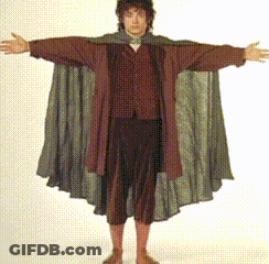 A Man With His Arms Outstretched Is Wearing A Cloak GIF