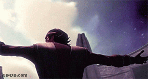 A Man With His Arms Outstretched Standing In Front Of A Building GIF