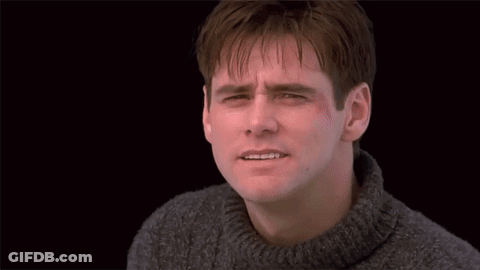 A Man With His Arms Outstretched Standing In Front Of A Door GIF