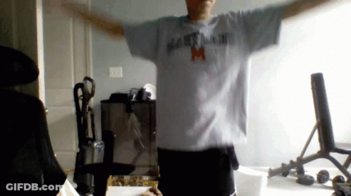 A Man With His Arms Outstretched Wearing A Maryland T-Shirt GIF