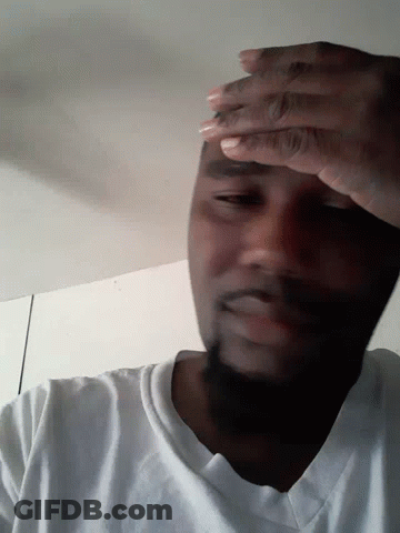 A Man With His Eyes Closed And His Hands On His Face GIF