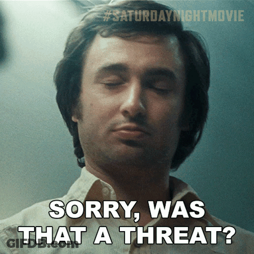 A Man With His Eyes Closed And The Words Sorry Was That A Threat Below Him GIF