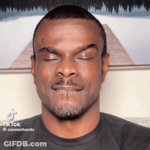 A Man With His Eyes Closed Has A Tiktok Watermark On His Face GIF