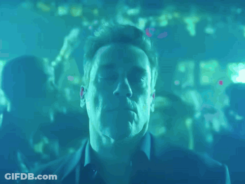 A Man With His Eyes Closed In A Blue Room GIF