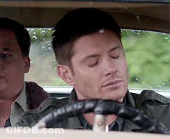 A Man With His Eyes Closed Is Driving A Car With Another Man In The Back Seat GIF