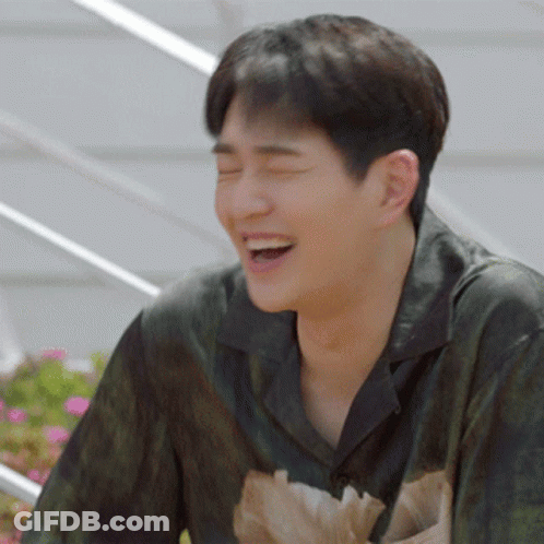 A Man With His Eyes Closed Is Laughing With His Mouth Open GIF