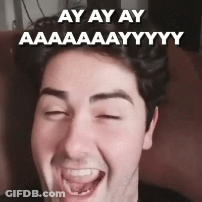 A Man With His Eyes Closed Is Making A Funny Face With His Tongue Out . GIF