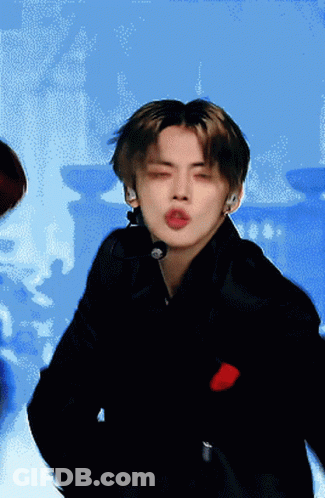 A Man With His Eyes Closed Is Wearing A Microphone On His Neck GIF