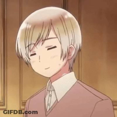 A Man With His Eyes Closed Is Wearing A Pink Sweater And White Shirt GIF
