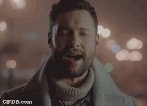 A Man With His Eyes Closed Is Wearing A Sweater GIF